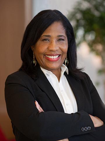 Headshot of Rochelle Smith, smiling while wearing a black blazer and white blouse.